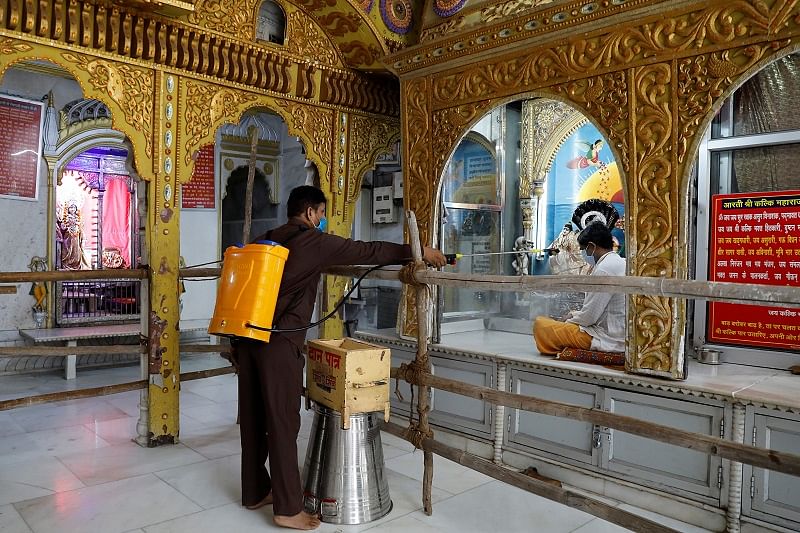 A man disinfects a temple after the opening of most of the religious places after India eases lockdown restrictions that were imposed to slow the spread of the coronavirus disease (COVID-19), in New Delhi. Credit: Reuters Photo