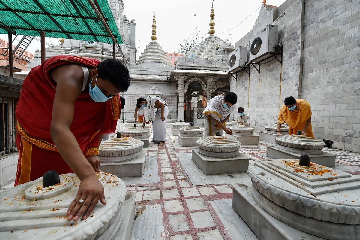 Monks prepare for the opening of Dudeshwaranath Mahadev Math for devotees, after COVID-19 lockdown restriction were eased, in Ghaziabad, UP. Credit: PTI Photo