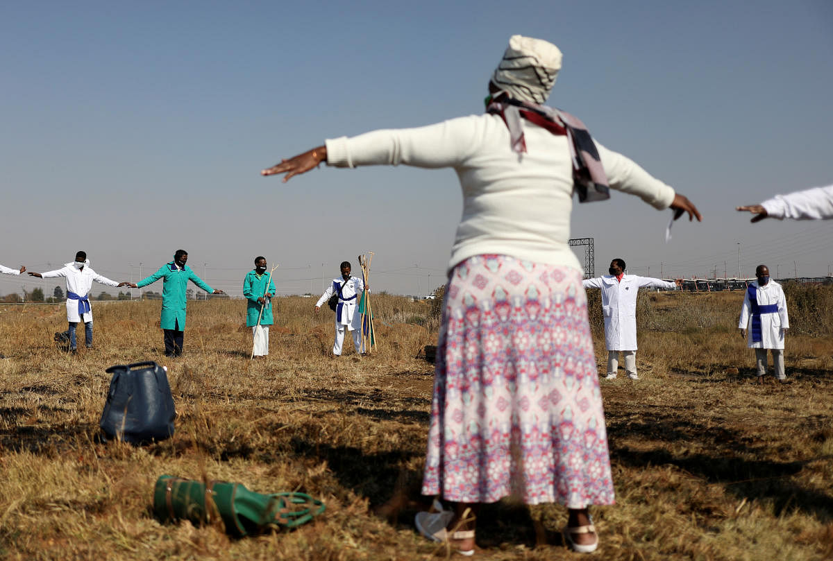 Congregants of the Inhlanhla Yokuphila Apostolic Church In Zion practice social distancing as they attend a church service at an open field, as South Africa loosens a nationwide lockdown aimed at limiting the spread of the coronavirus disease (COVID-19) in Soweto, South Africa. Credit/Reuters Photo