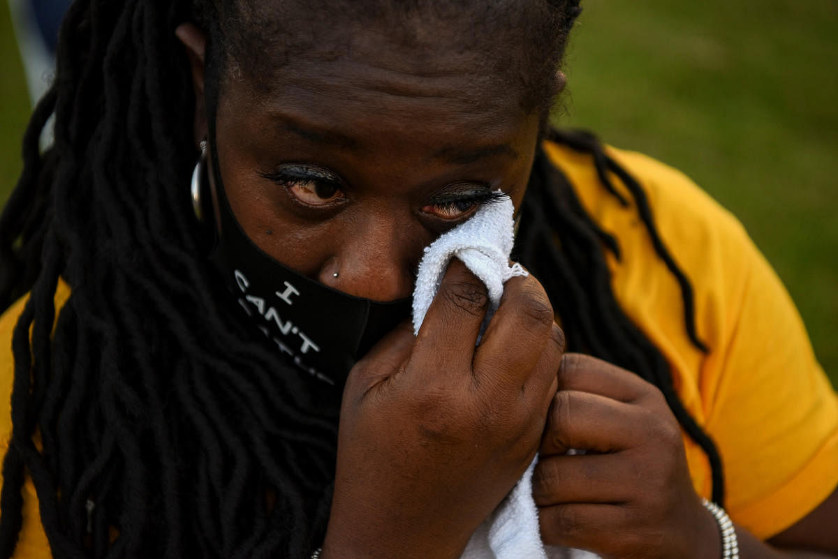 Camrahn Johnson wipes a tear as hundreds attend a vigil for George Floyd, whose death in Minneapolis police custody has sparked nationwide protests against racial inequality, in Houston, Texas, U.S. June 8, 2020. Credit/Reuters Photo
