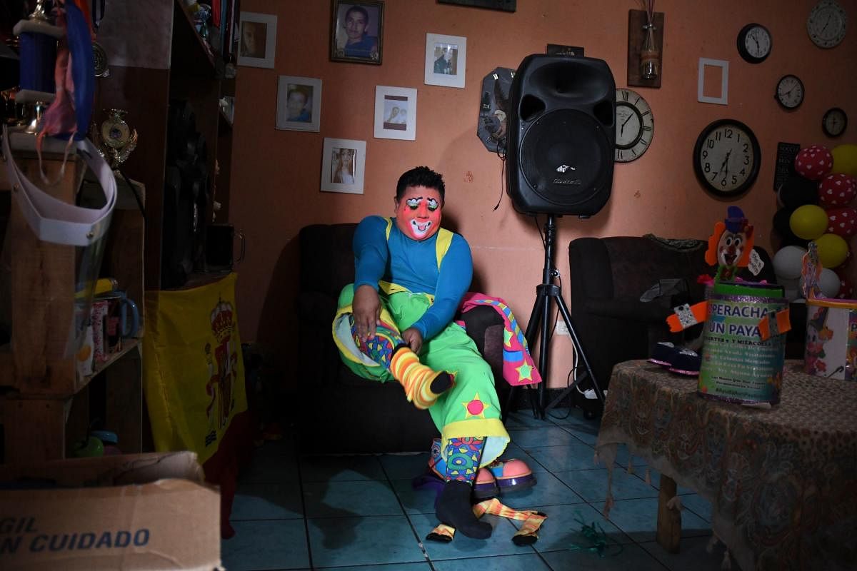 Mostacita.com clown prepares before taking to the streets to beg for money to survive the crisis caused by the new coronavirus in Villa Nueva, 20 km south Guatemala City. Credit/AFP Photo