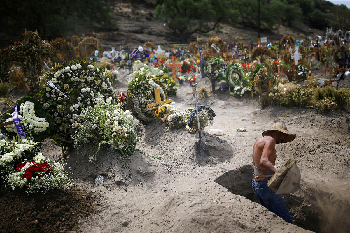 A cemetery worker dig new graves at the Xico cemetery on the outskirts of Mexico City, as the coronavirus disease (COVID-19) outbreak continues in Mexico. Credit/Reuters Photo