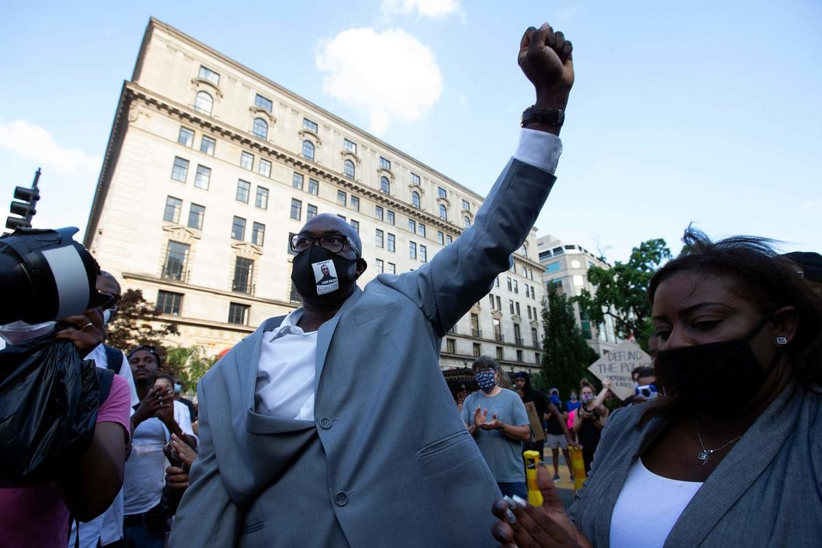 Philonise Floyd (C), George Floyd's brother, holds up his fist as he marches with others on Black Lives Matter Plaza near the White House, to protest police brutality and racism. Credit/AFP Photo