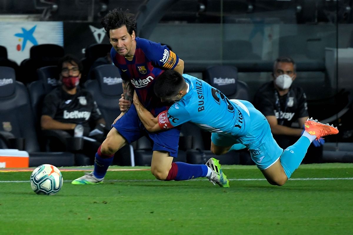Barcelona's Argentine forward Lionel Messi (L) is tackled by Leganes' Spanish defender Unai Bustinza during the Spanish league football match. Credit: AFP Photo