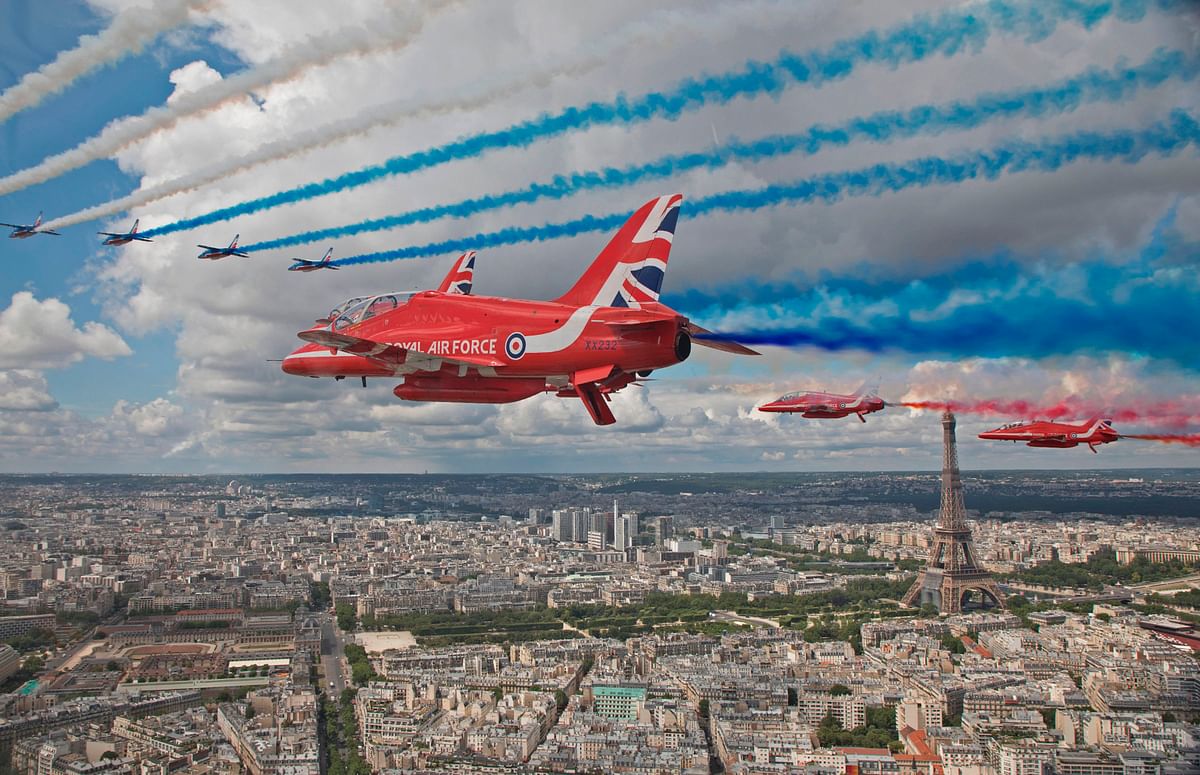 The Royal Air Force Aerobatic Team, the Red Arrows, and the French Air Force Aerobatic Team, La Patrouille de France, perform a fly-past over Paris, France. Credit: AFP Photo
