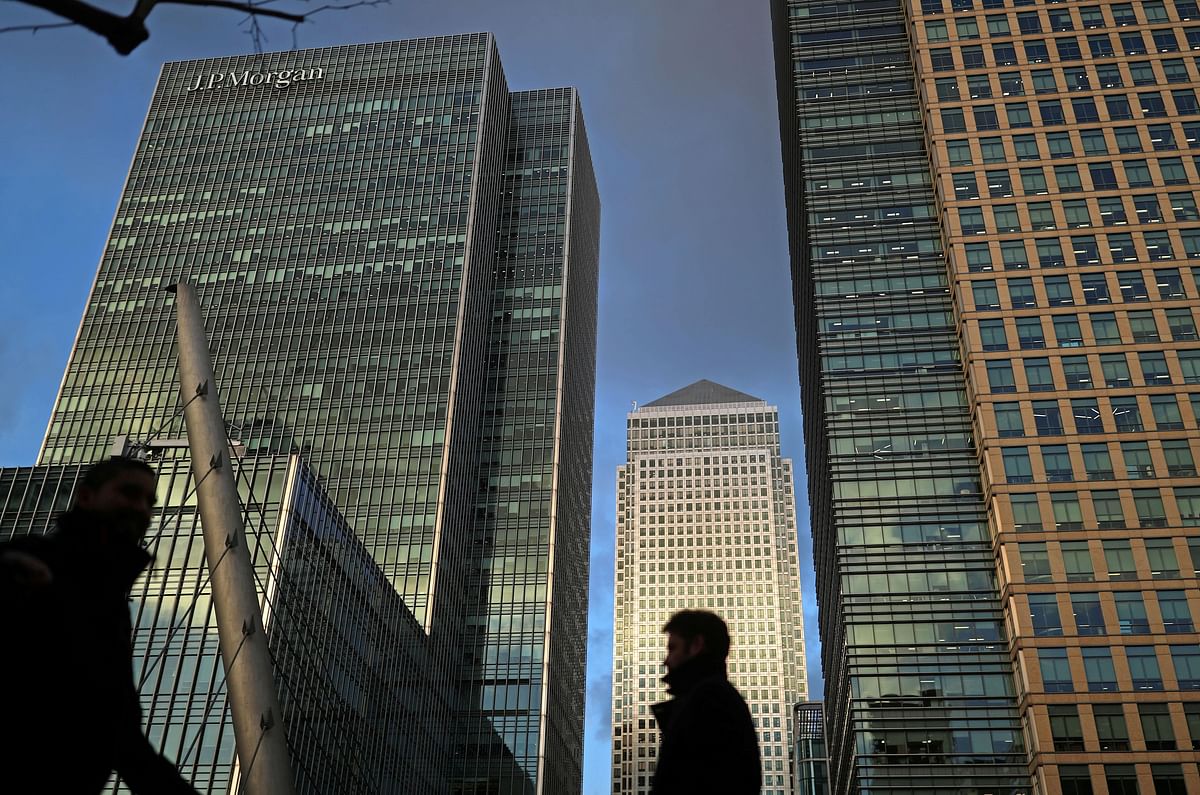 People walk through the Canary Wharf financial district of London, Britain. Credit: Reuters Photo