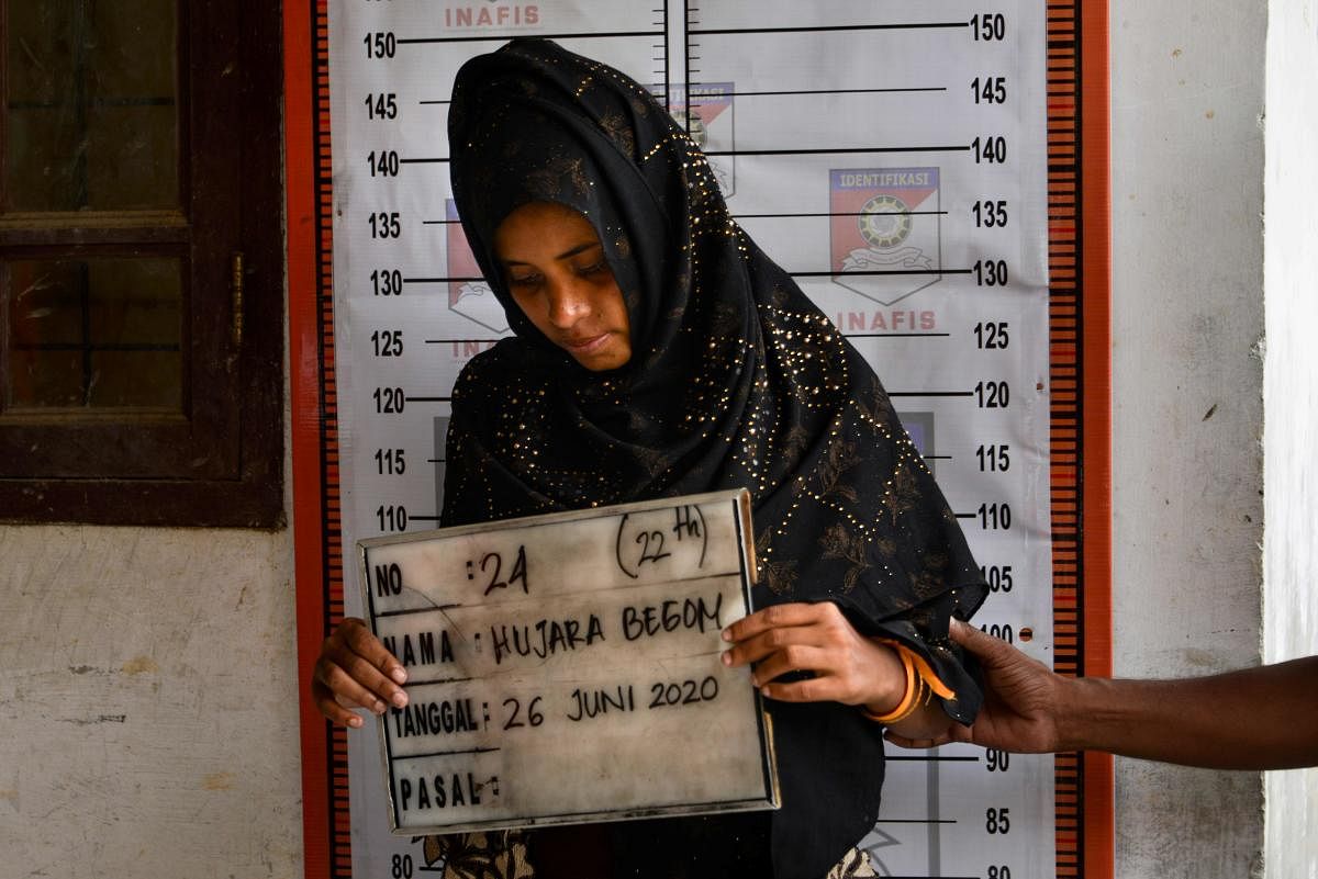 A Rohingya woman from Myanmar goes through an identification procedure by Indonesia police at the immigration detention centre in Lhokseumawe in Indonesia's North Aceh Regency on June 26, 2020. Credit/AFP Photo