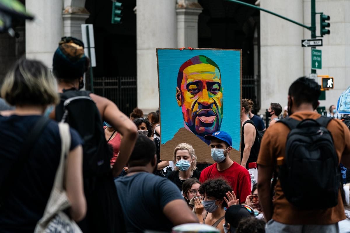 A portrait of George Floyd is seen during a protest encampment on Jne 28, 2020 in a park near City Hall in New York City. Demonstrations continue with protests and demands for lawmakers to cut the New York Police Department's (NYPD) budget. Jeenah Moon/Getty Images/AFP