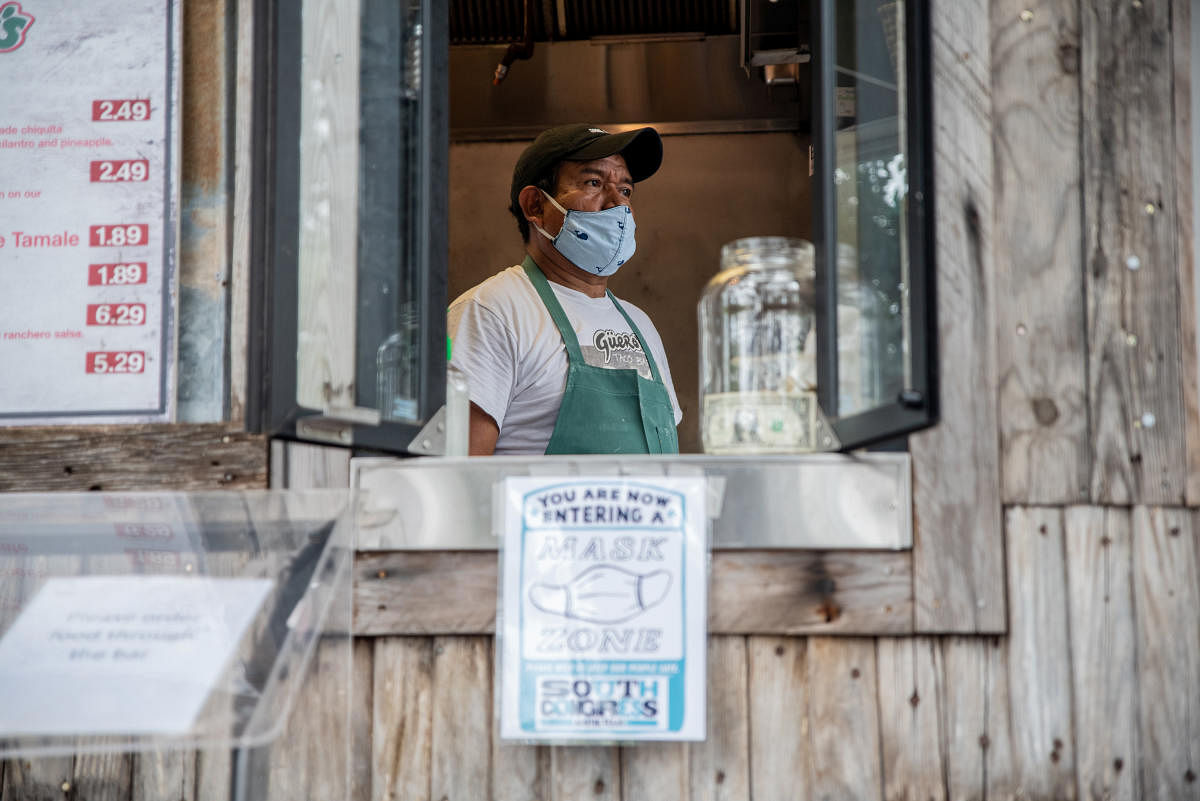 A worker at a taco stand looks out of a window amid the global outbreak of the coronavirus disease (Covid-19), in Austin, Texas. Reuters