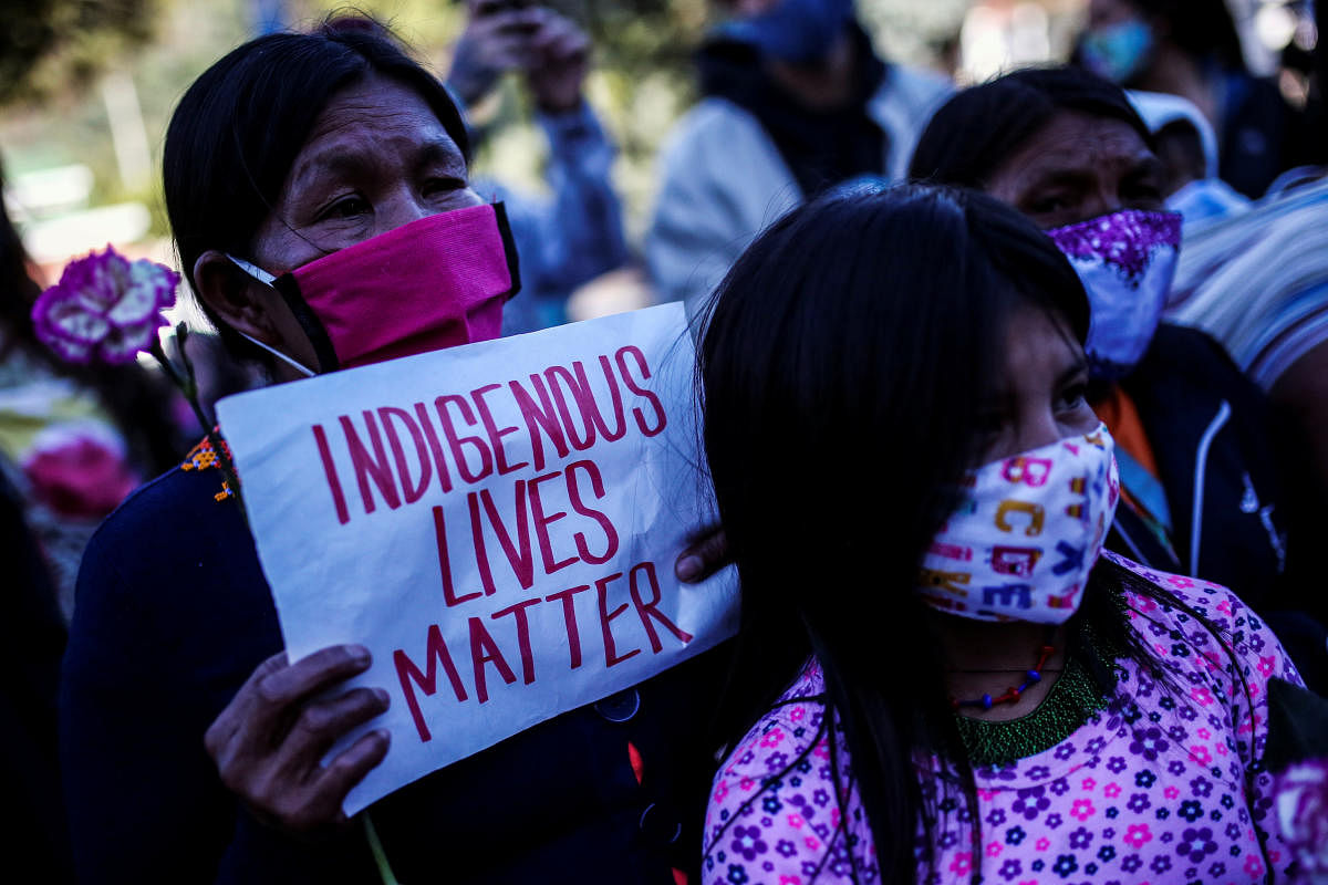 Demonstrators wearing face masks protest in front of a military battalion, against the reported rape of an Embera Chami indigenous girl by soldiers, in Bogota, Colombia. Reuters