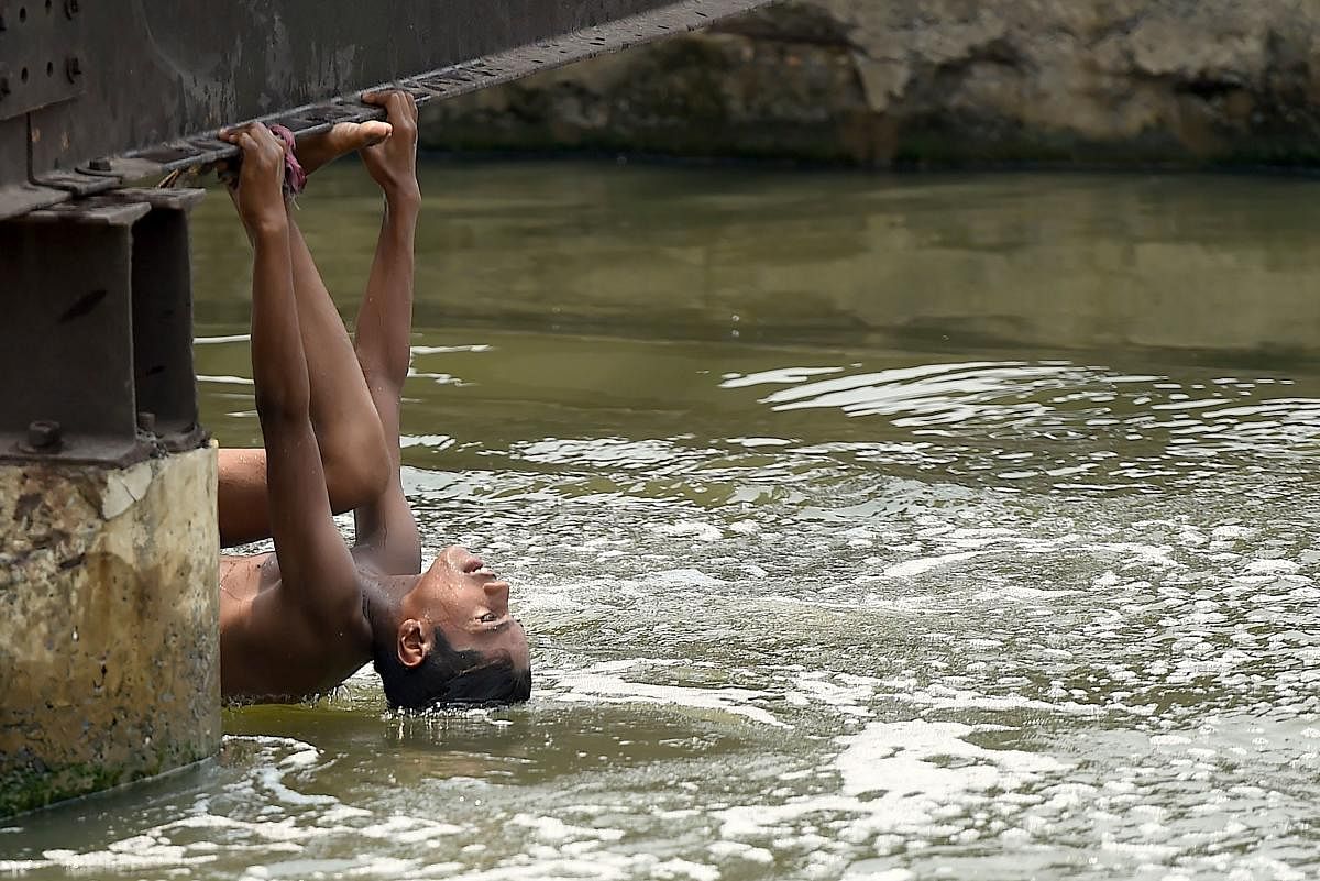 A youth cools himself off amid rising temperatures, in New Delhi on July 3, 2020. Credit/AFP Photo