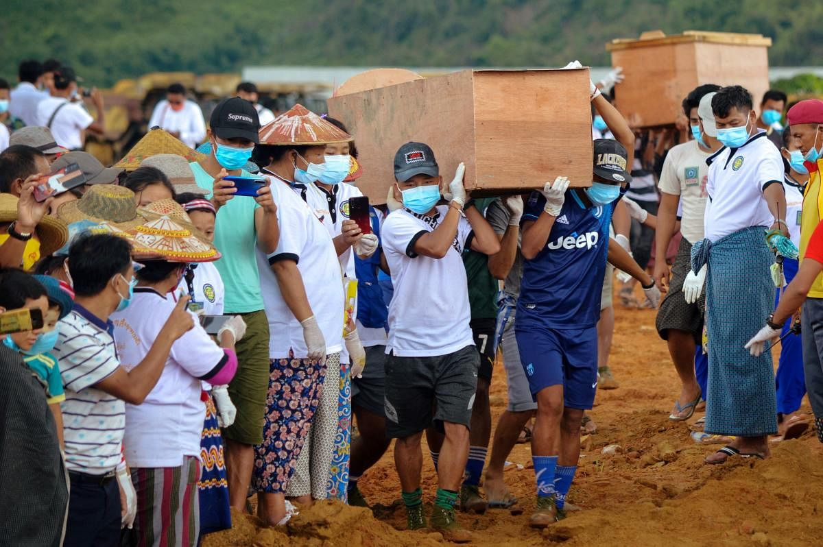 Volunteers carry coffins containing bodies of victims following a landslide at a mining site in Hpakant, Kachin State City, Myanmar July 3, 2020. Credit/Reuters Photo