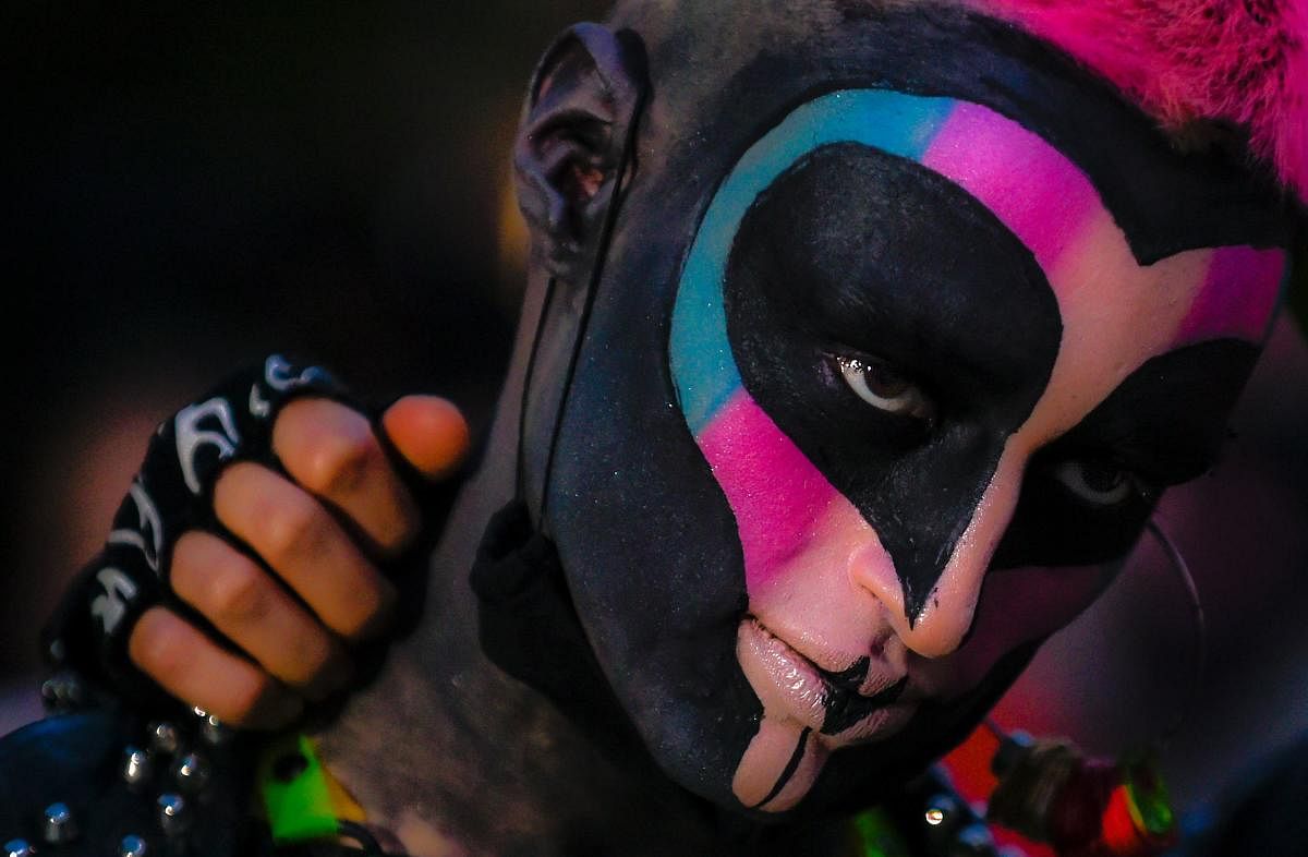 A demonstrator with the face painted takes part in a protest against the recent unsolved murders of several members of the LGBT community, in Bogota on July 3, 2020, amid the new coronavirus pandemic. AFP