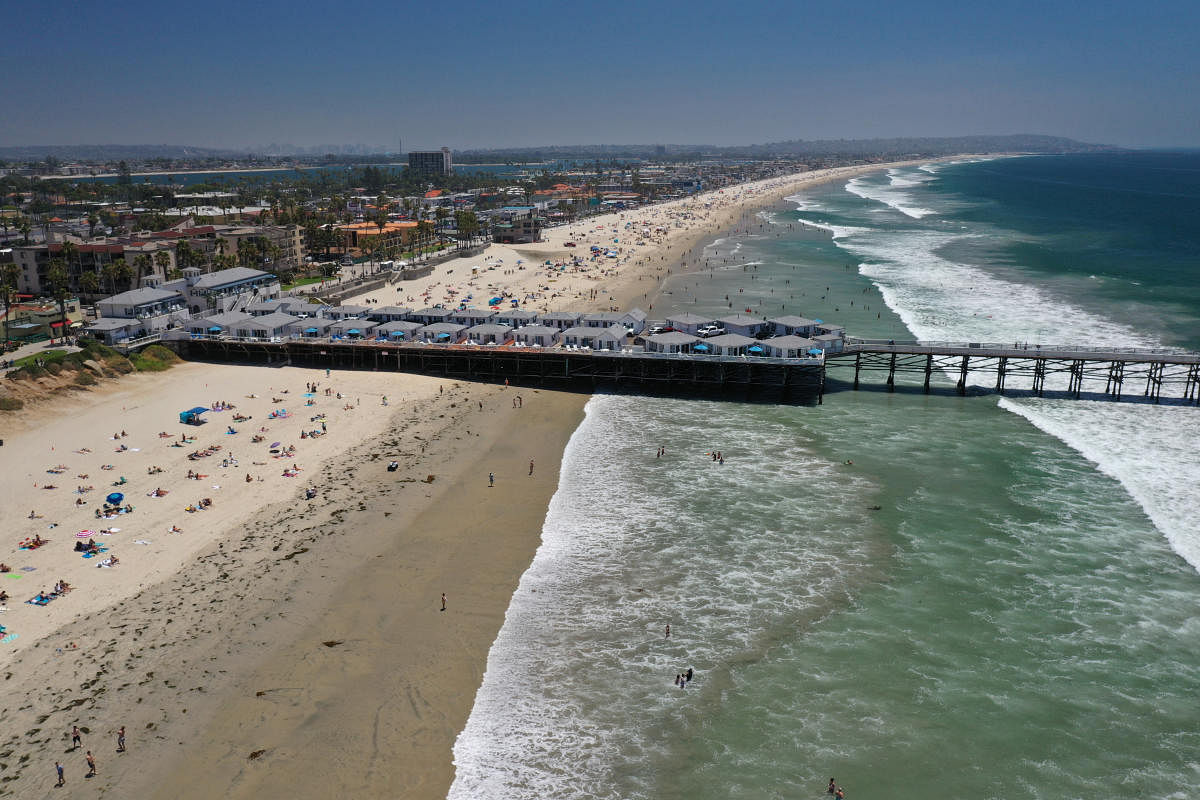 People crowd Pacific Beach and Crystal Pier in this aerial photograph taken over San Diego, California. Reuters