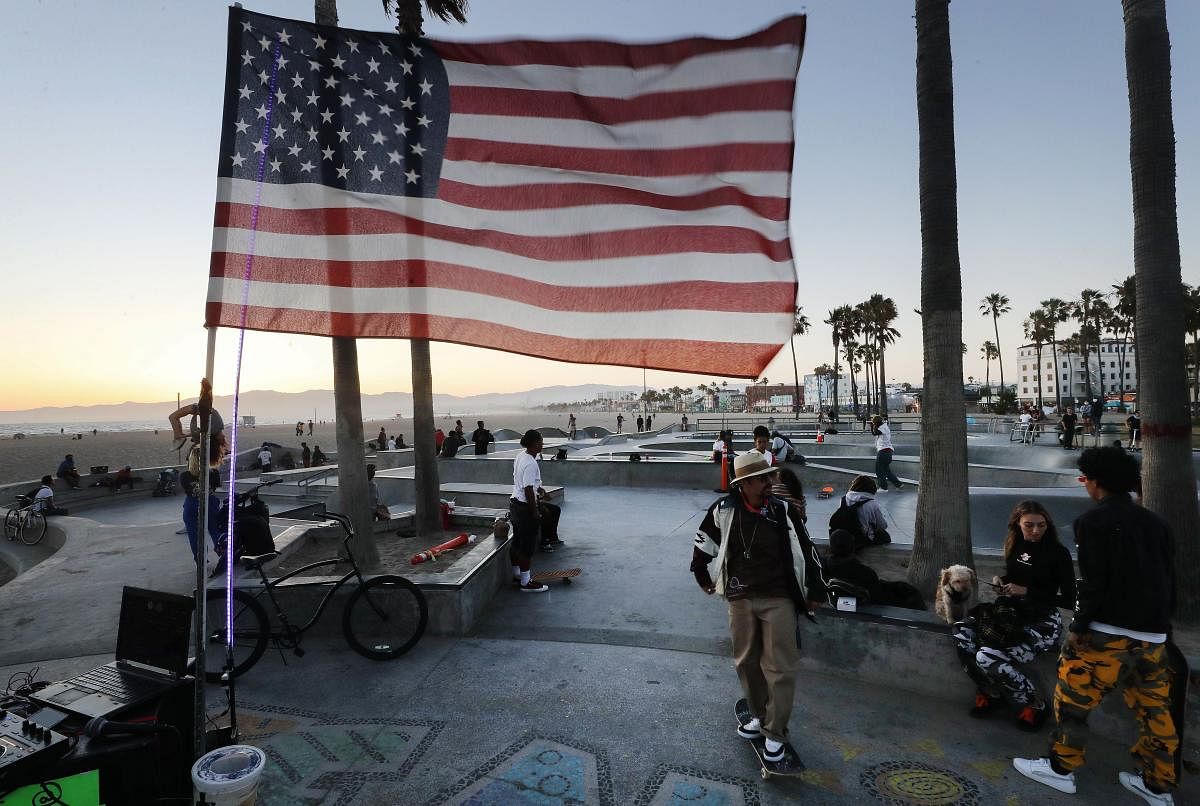 An American flag flies as people gather at Venice Skate Park, which remains open along the closed and mostly empty Venice Beach, amid the Covid-19 pandemic in Venice, California. Mario Tama/Getty Images/AFP