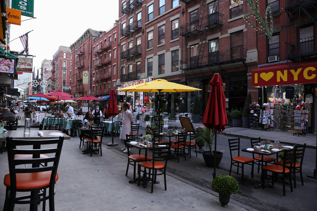 People dine outside on Mulberry Street in lower Manhattan, New York. Credit: Reuters