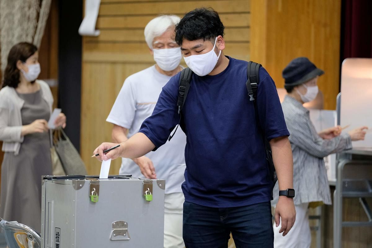 A man casts his vote for the Tokyo gubernatorial election at a polling station in Shinjuku area in Tokyo. Credit: AFP