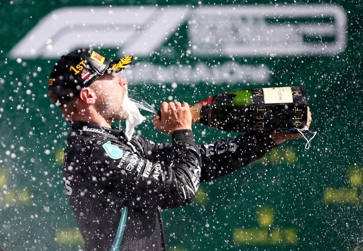 Mercedes driver Valtteri Bottas of Finland sprays champagne after winning the Austrian Formula One Grand Prix at the Red Bull Ring racetrack in Spielberg, Austria. Credits: AP Photo