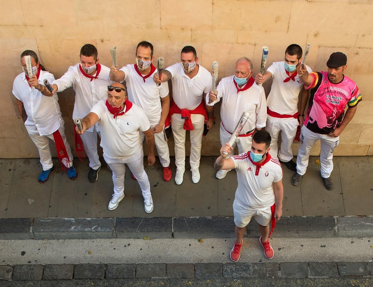 Participants sing to San Fermin, the town's patron saint, during the symbolic celebration of the first bullrun of the San Fermin festival in Pamplona, northern Spain, on July 7, 2020. Credit: AFP