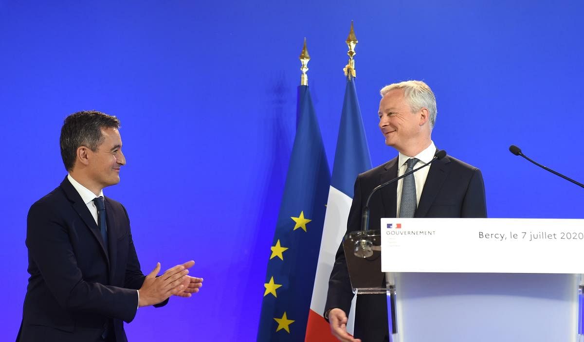 Newly appointed Interior Minister Gerald Darmanin applauds French Minister of the Economy and Finance Bruno Le Maire (R) during the handover ceremony at the French Economy and Finance Ministry in Paris on July 7, 2020 following the French cabinet reshuffle. Credit: AFP