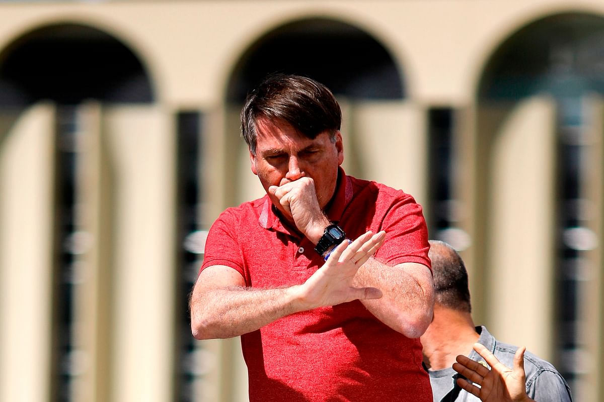 June 23 - A judge orders Bolsonaro to wear a mask in public after he attended political rallies without one. Credit: AFP