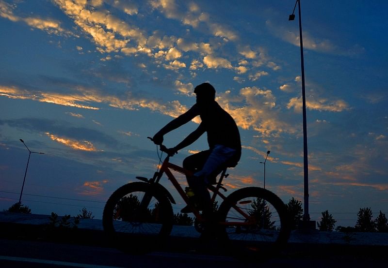 A cyclist is silhoutted against the evening sky, during Unlock 2.0, in Amritsar. Credits: PTI Photo