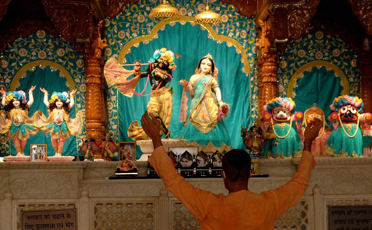 A devotee offers prayers at a Iskcon temple after it re-opened, during Unlock 2.0, in Noida. Credits: PTI Photo