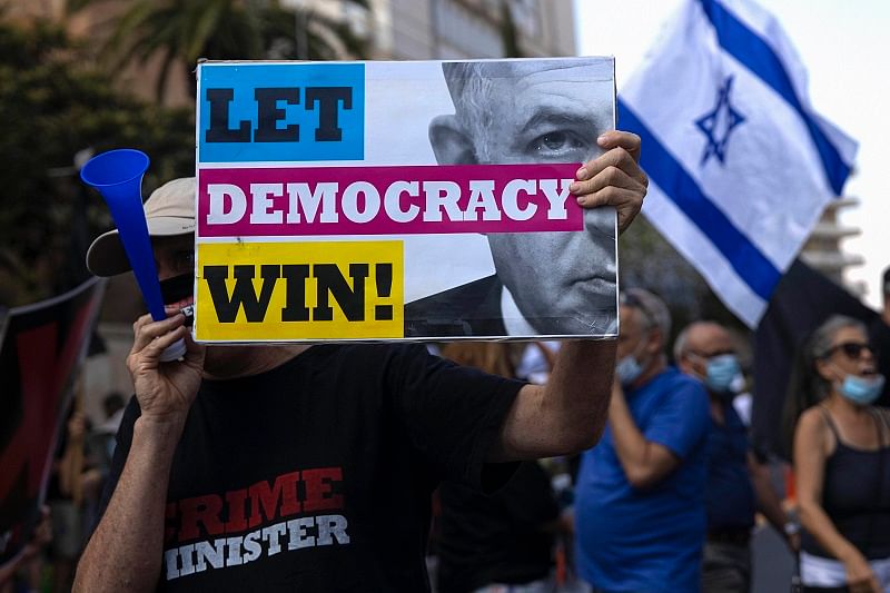 An Israeli protester hold a sign during the