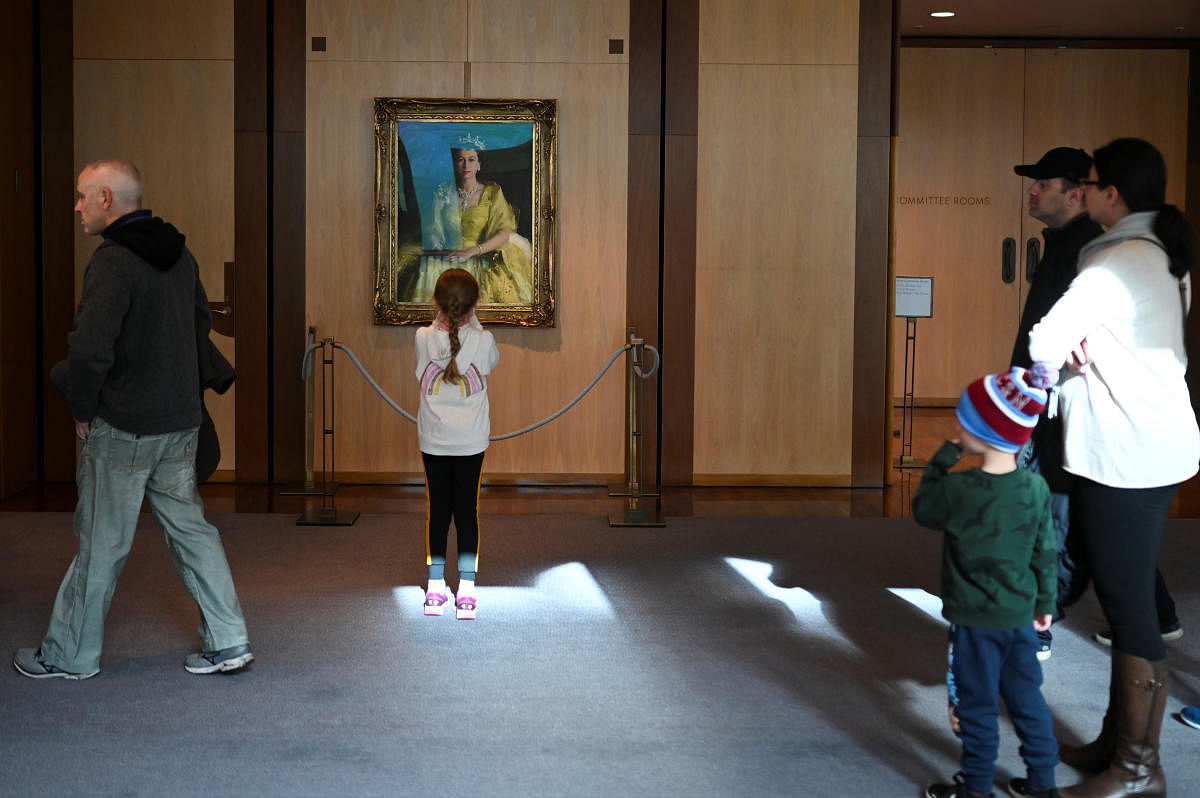 A girl takes a photo of a portrait of Queen Elizabeth at Parliament House in Canberra (Reuters Photo)