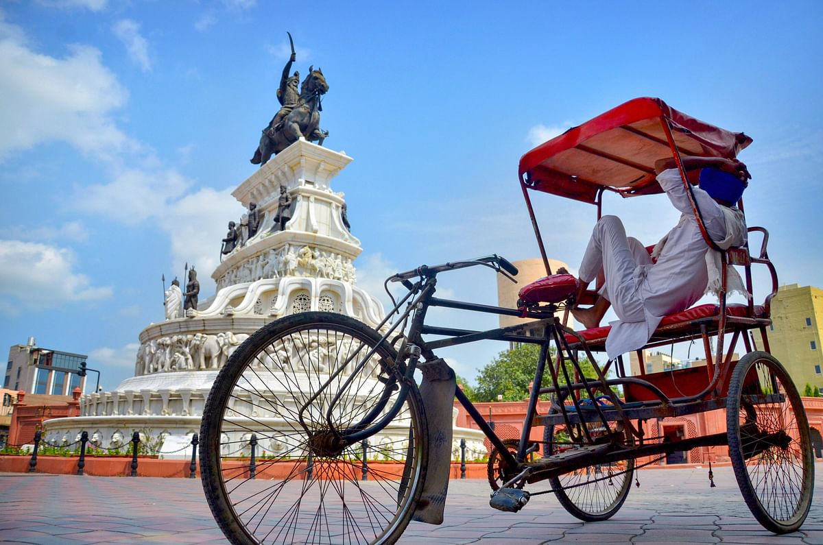 A rickshaw puller waits for passengers on Heritage street near Golden Temple, during the complete lockdown on weekend imposed by the state government as a preventive measure against the coronavirus. Credits: PTI Photo