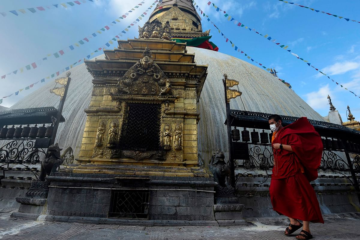 A Buddhist monk walks at the Swayambhunath Stupa in Kathmandu on July 13, 2020. Credit: AFP