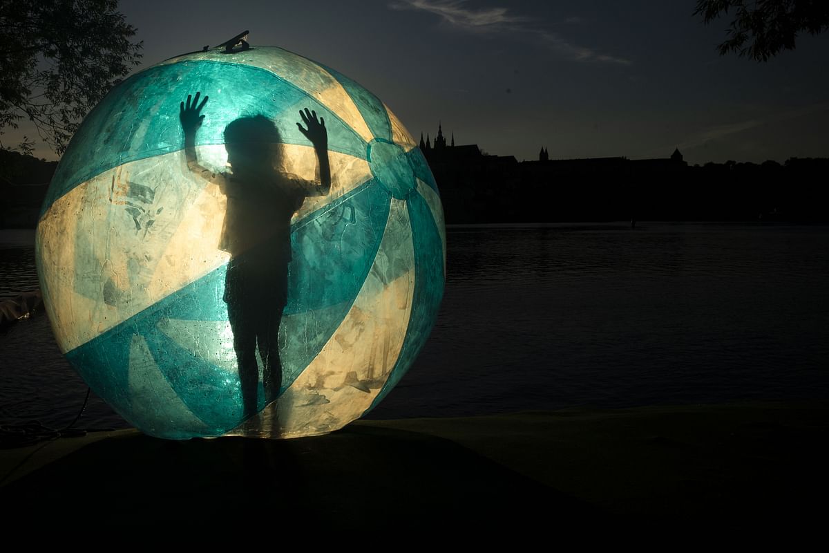 A tourist enjoys standing inside a zorb ball on the bank of Vltava river on July 13, 2020 in Prague. Credit: AFP