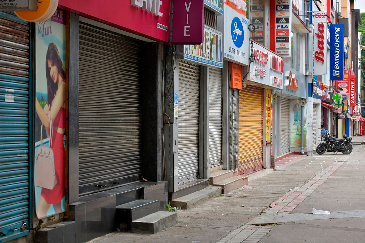 Closed shops are pictured in a commercial area during a week-long lockdown to contain the surge of COVID-19 coronavirus cases, in Bangalore. Credits: AFP Photo