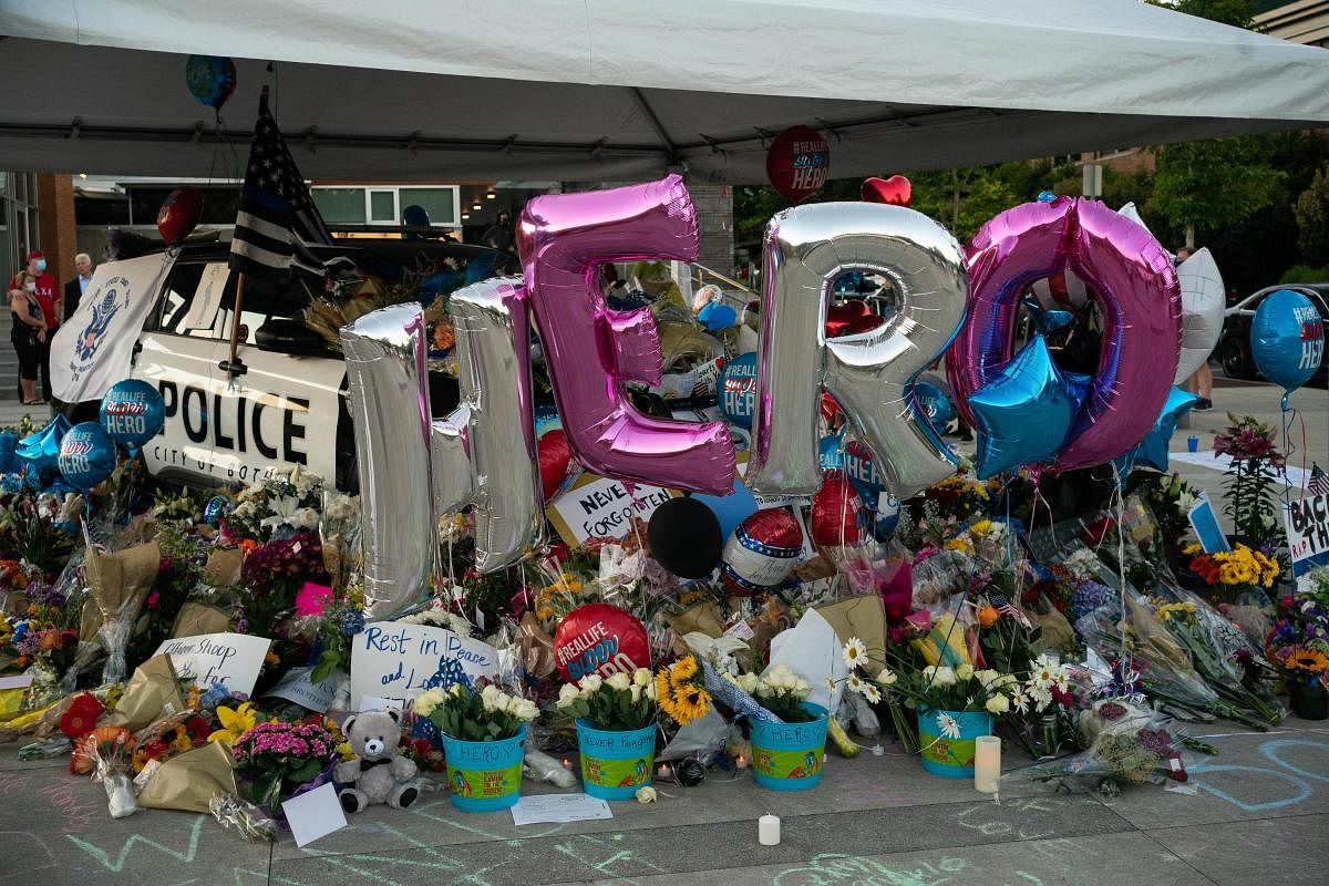 A general view of a memorial for slain Police Officer Jonathan Shoop outside the Bothell Police Department . Credit: AFP