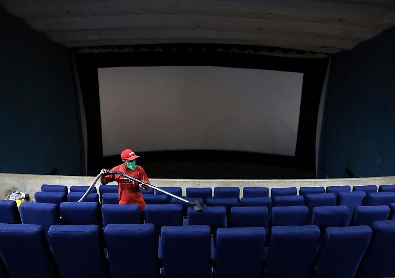 A worker cleans the seats during a routine cleaning of Navina cinema hall that was closed following the outbreak of the coronavirus disease (COVID-19), in Kolkata. Credits: Reuters Photo
