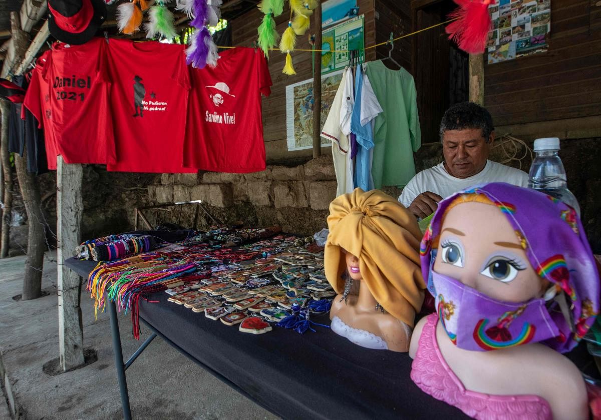 A street vendor sits next to T-shirts referring to Nicaraguan President Daniel Ortega's candidacy for reelection on 2021, in Catarina, Nicaragua. Credit: Reuters