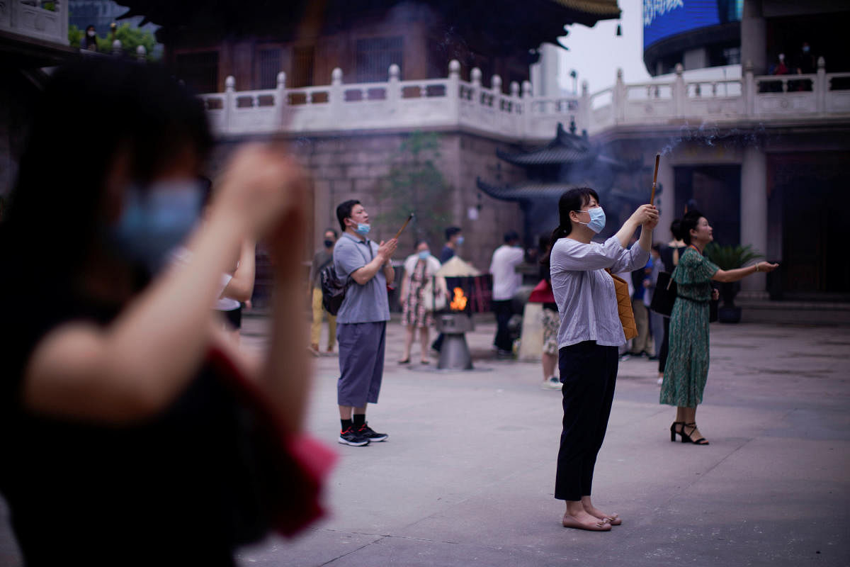 People worship at the Buddhist Jing'an Temple in Shanghai as it reopens following the coronavirus disease (COVID-19) outbreak, China. Credit Reuters