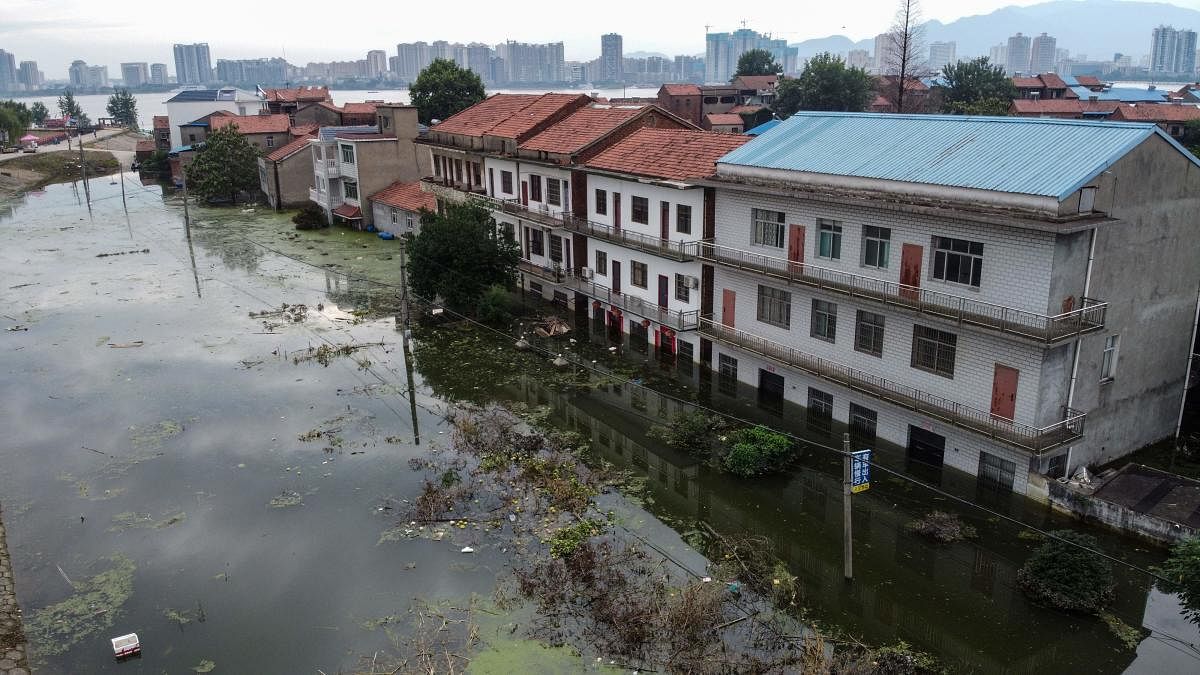 An aerial view shows flooded residential buildings due to rising water levels of the Yangtze river in Jiujiang, China. Credit AFP