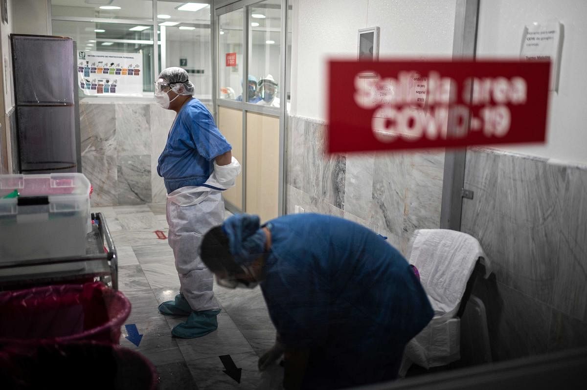 Health workers take off their personal protective equipment (PPE) after their shifts at the COVID-19 area of the 32nd Zone General Hospital of the Mexican Social Security Institute (IMSS) in Mexico City, on July 20, 2020, amid the new coronavirus pandemic. Credit: AFP Photo