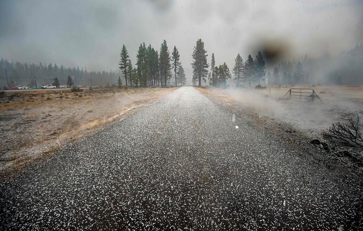 Hail covers a road in at a still smoldering area of the Hog fire near Susanville, California. Credit: AFP