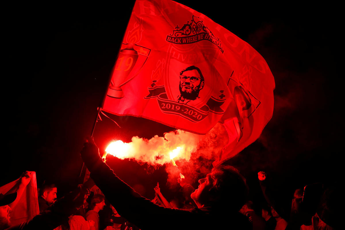 Liverpool fans celebrate with flares outside the stadium after the match. Credit: Reuters