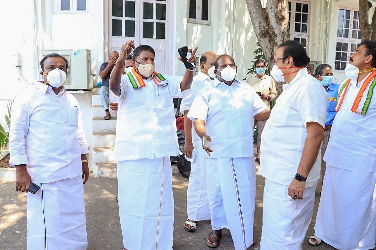 Puducherry Chief Minister V Narayayanasamy (2nd L) with Speaker Sivakozhundu and other leaders visit the garden area of the Assembly premises to convene its session as the hall was being disinfected in the view of coronavirus pandemic. Credit: PTI