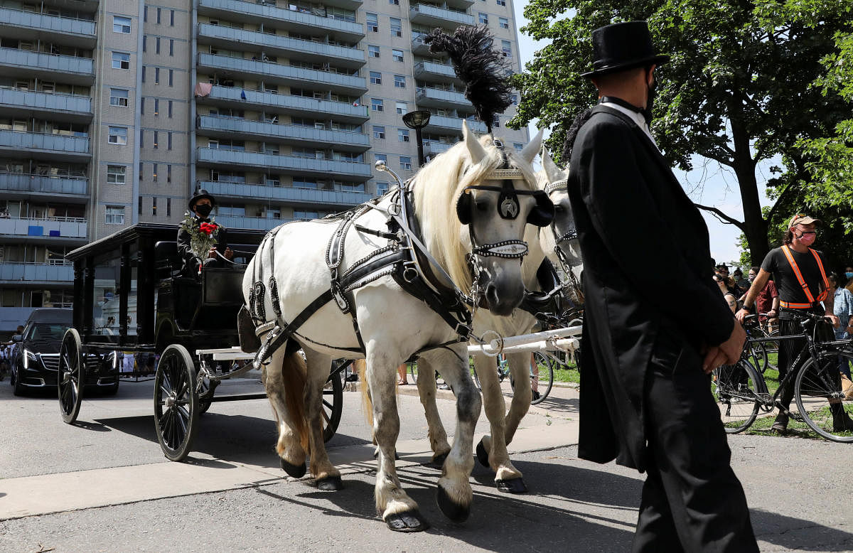 A horse drawn carriage containing an empty coffin is seen during a memorial and a march in the name of Regis Korchinski-Paquet, a Black and Indigenous woman who fell to her death on May 27, 2020, from a balcony. Credit: Reuters