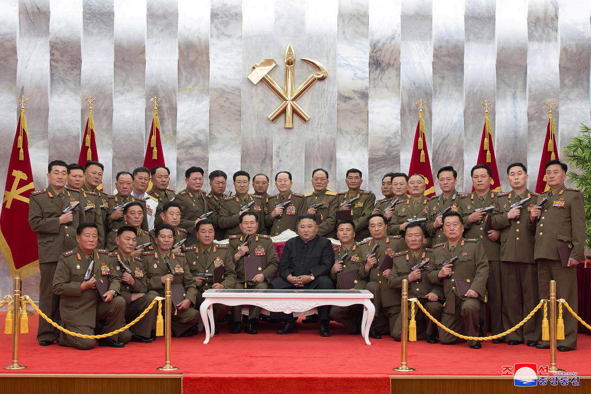 North Korean leader Kim Jong Un poses for a photograph after conferring