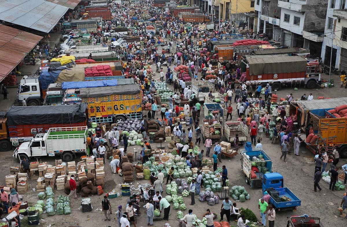 A view of a wholesale vegetables market showing no respect to social distancing guidelines, during Unlock 2.0 in Jammu, Monday, July 27, 2020. Credit: PTI Photo