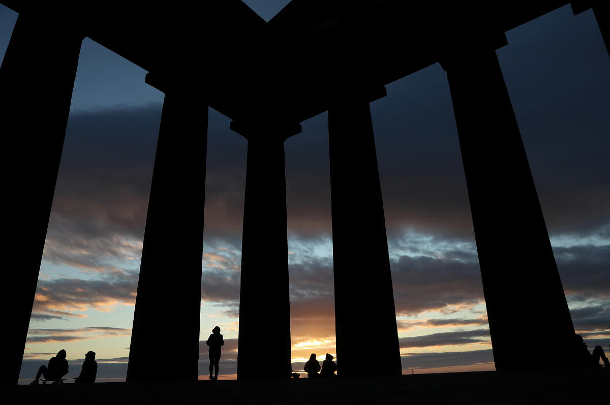 People watch the sunrise from Penshaw Monument, County Durham, Britain. Credit: Reuters