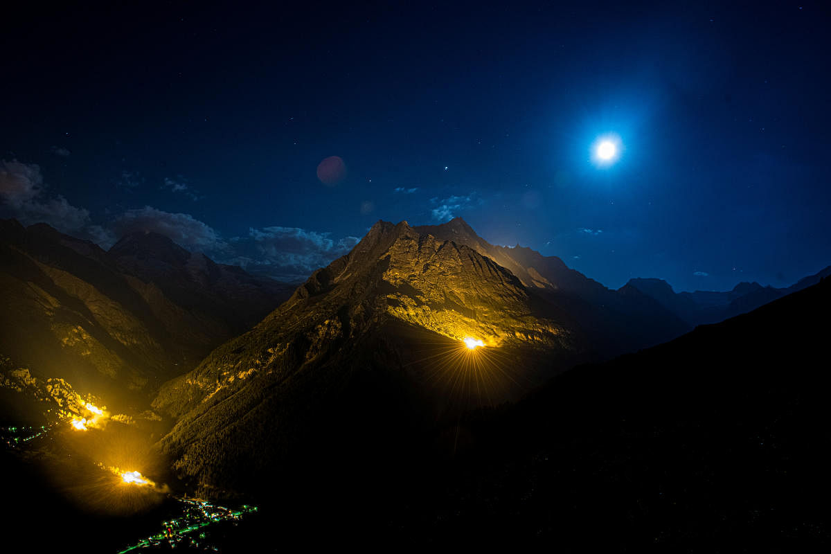 The mountain chains of Veisivi and Dent de Perroc are illuminated to celebrate Swiss National Day in Evolene. Credit: Reuters