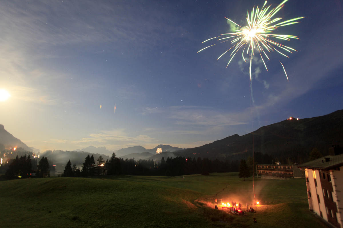 A long exposure shows people celebrating the Swiss National Day with fireworks. Credit: Reuters