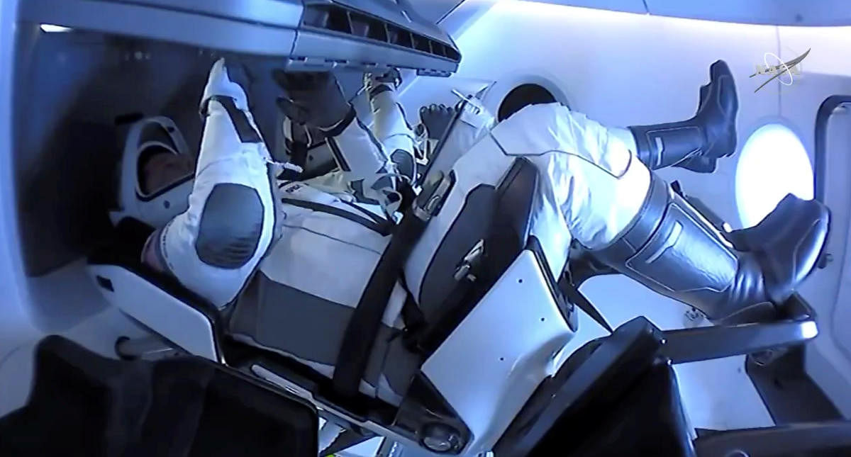 NASA astronauts Robert Behnken and Douglas Hurley are seen aboard SpaceX's Dragon Endeavour spacecraft, August 2, 2020, in this screen grab taken from a video. Credit: NASA/Handout via REUTERS