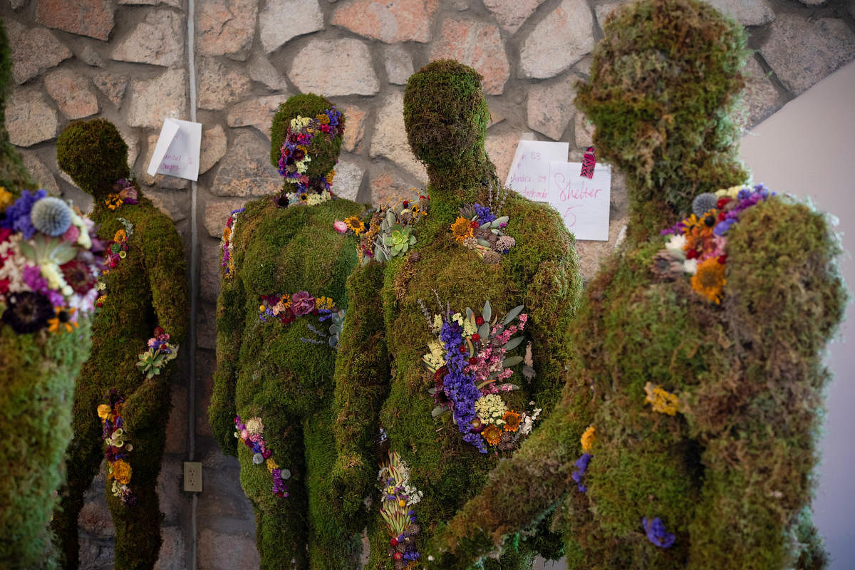 Mannequins representing the 23 victims of the Walmart mass shooting are covered in moss and flowers to symbolize life unity and eternal growth, at Ascarate Park, in El Paso, Texas, U.S., August 2, 2020. The mannequins will be displayed at the Healing Garden Memorial that families will attend marking the one year anniversary of the shooting at the El Paso Walmart. Credit: REUTERS